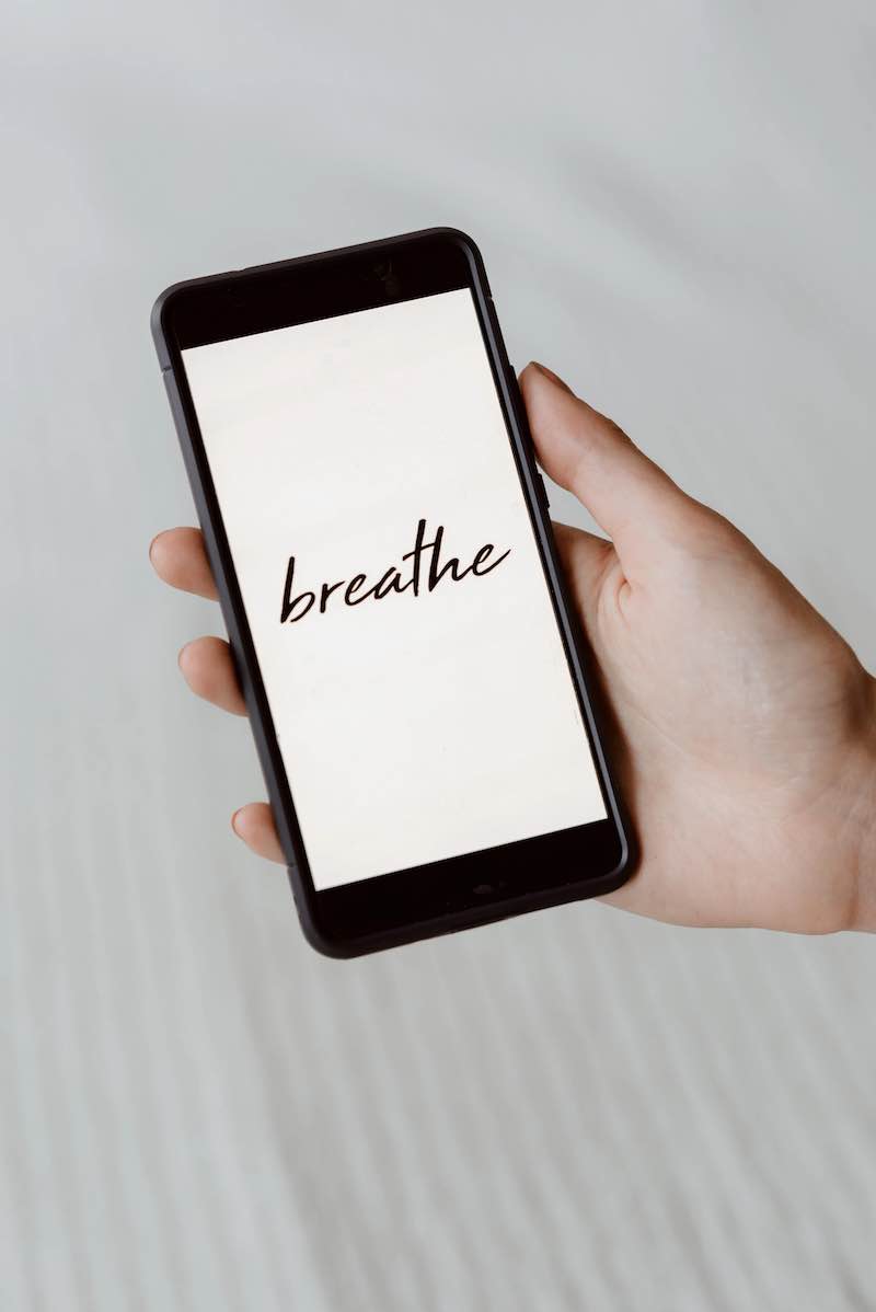 Smartphone with the word "breathe" on the screen